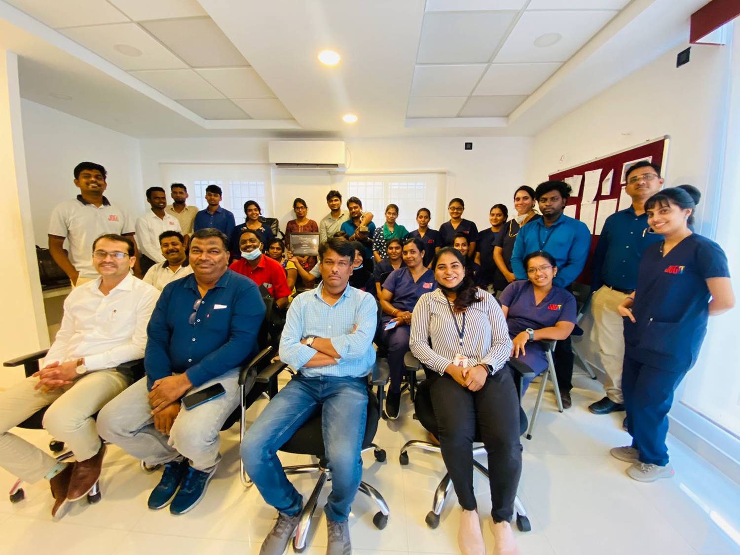 JOGO staff and team with cheerful expressions.