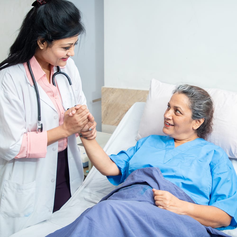 Medical staff attending an elderly woman.