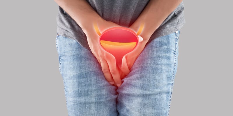 A young person experiencing urinary hesitancy represented with a vector image of a bladder.
