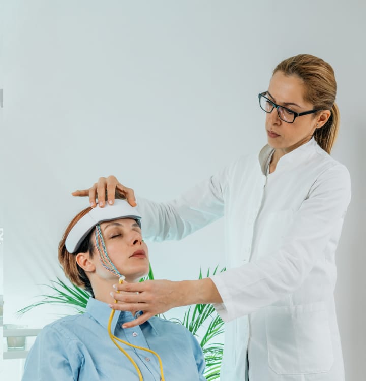 A doctor conducts an EMG biofeedback session with a patient.